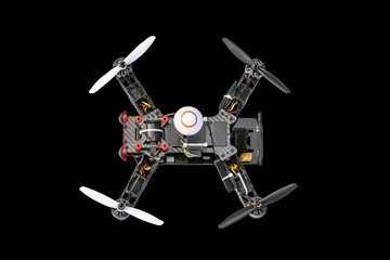 Dron, quadro copter Isolated on black background, closeup.