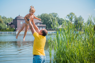 Obraz premium Concept of children life. Little child having fun in a beach. Happy child playing in the nature . Kid having fun outdoors. Summer vacation and healthy lifestyle 