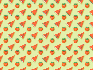 top view of textured pattern with handmade paper strawberries and watermelon slices isolated on green