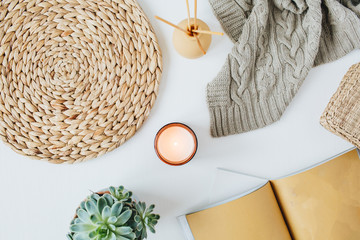 Boho style modern minimal home workspace desk with notebook, succulent, knitted plaid, candle,...