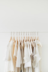 Feminine clothes on hanger. Minimal fashion composition on white background. Lifestyle concept.