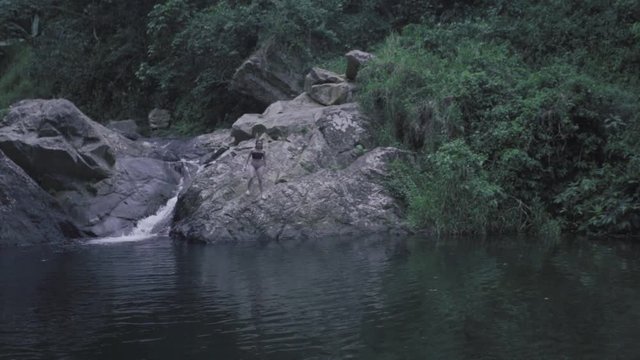 SLOW MOTION: girl dives into the base of Mango Waterfall in Adjuntas, Puerto Rico.