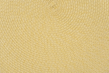 Woven yellow wicker straw background or textur
