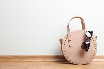  round female handbag and sunglasses