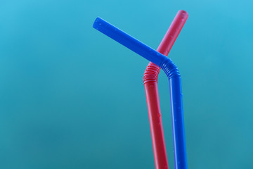 red and blue plastic straw on water background for drink or environment conservation background