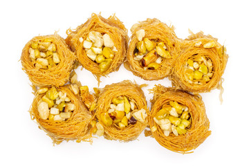 Group of seven whole sweet lebanese baklava piece bird nest variety flatlay isolated on white...