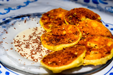 Cheesecakes with sour cream and chocolate chips on plate.