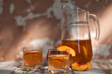 Ice tea and nectarine. Jag, two glasses.  A refreshing summer drink
