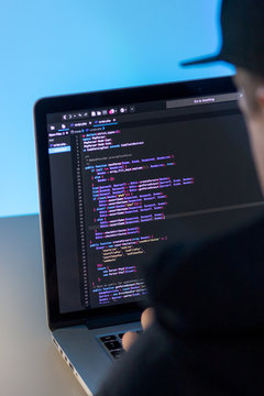 Programmer working on laptop computer in office