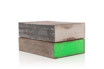 Group of two whole green and grey abrasive block sponges work item isolated on white background