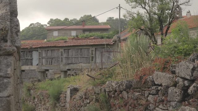 Dolly shot of a granary called espigueiro in a rural village on a hill Friaes Tras-os-Montes Portugal