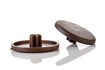 Group of two whole brown plast caps work item isolated on white background