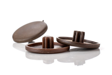 Group of three whole dark brown plast plugs work item isolated on white background