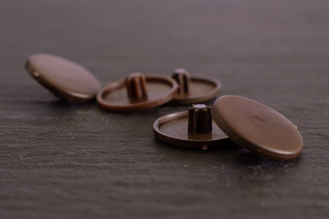 Group of five whole brown plast caplugs work item on grey stone