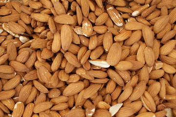 Overhead view of raw organic almonds as a background. Peeled almond nuts. Healthy food concept. Vegetarian. 