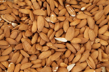 Overhead view of raw organic almonds as a background. Peeled almond nuts. Healthy food concept. Vegetarian. 