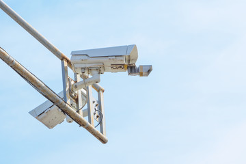 Modern speed control camera close-up on the background blue sky.