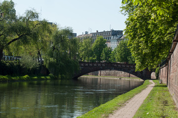 bridge and trees on channel at little France quarter in Strasbourg