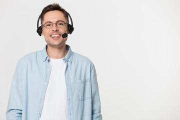 Smiling man in glasses and headset isolated on studio background