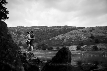 Couple embracing with a dramatic black and white background