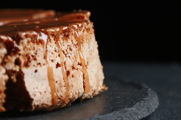pie with caramel close up on dark background. cake with banana and caramel