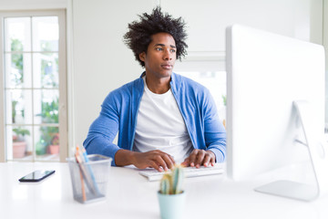 African American man working using computer with a confident expression on smart face thinking serious