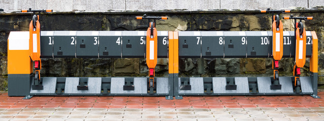 Kick scooters rental station. Folded transport equipment © lilkin