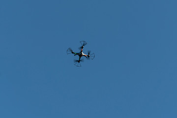 Drone flying in the air against the blue sky.technology and radio-controlled machines