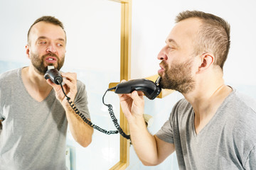Man shaving trimming his beard