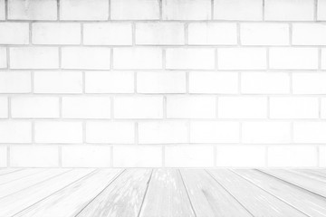 White Wood Table with Brick Wall Background.