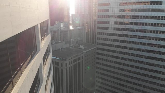 Aerial footage of downtown Minneapolis, crossing by buildings, sunny afternoon
