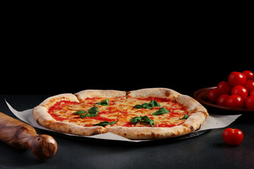 margarita pizza on dark background. traditional pizza concept