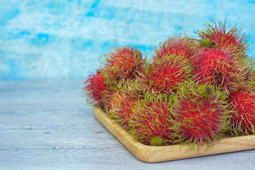 Rambutan fruit on wood trey