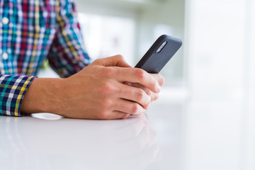 Close up of man hands using smartphone and smiling