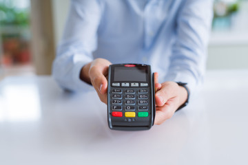 Close up of man hands holding pos terminal