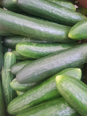 fresh cucumbers on the counter of a grocery store