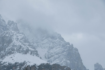 Naklejka na ściany i meble Clouds over the mountains in winter. Cortina d’Ampezzo Italy
