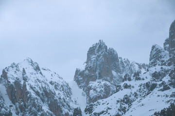 Fototapeta na wymiar Clouds over the mountains in winter. Cortina d’Ampezzo Italy