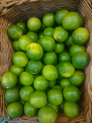 Background of fresh green limes closeup, fruits on sale, mobile photo