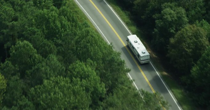 Aerial, cars drive on rural road in Atlanta