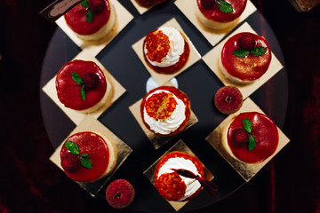 cupcakes decorated with raspberries and mint leaves. Top view