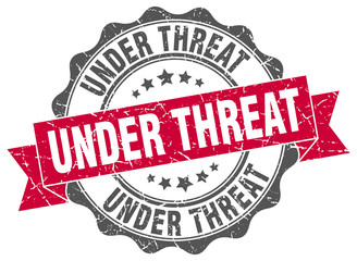 Obraz premium under threat stamp. sign. seal