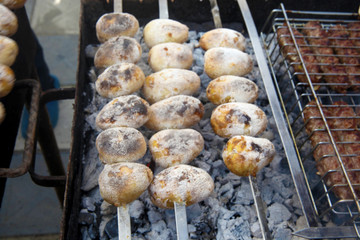 Vegetarian skewers made from potatoes on the grill outdoors 