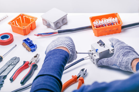 electrician with tools and electrical equipment