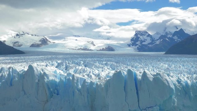 Zooming out to revel a massive glacier and it&rsquo;s crevasses.