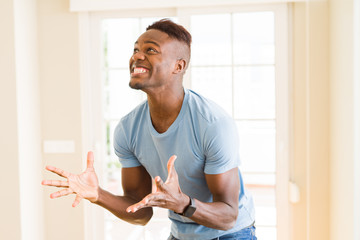 African American man screaming very excited and celebrating success and victory, smiling happpy and cheerful