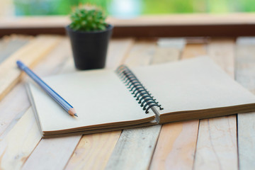 man business inspection Notepad with pencil on wood board background.using wallpaper for education, business photo.Take note of the product for book with paper and concept, object or copy space.