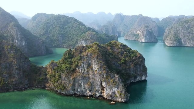 Aerial drone shot over Ha Long Bay, blue sea and limestone islands of Lan ha bay. Vietnam