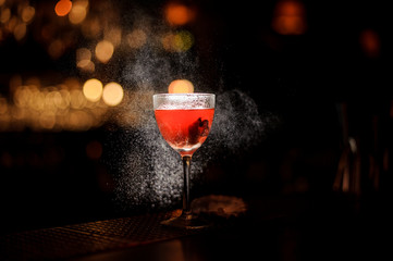 Close-up of alcohol cocktail with sprayed cloud around it