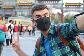 Tourist taking a selfie with breathing mask